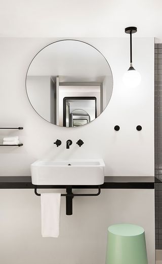 The washbasin with circular mirror.
