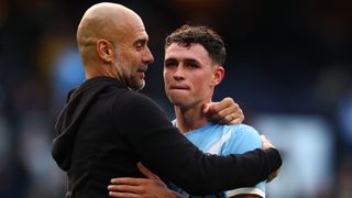 Manchester City Manager Pep Guardiola celebrates the 3-0 win with Phil Foden during the Premier League match between Manchester City and Manchester United at Etihad Stadium on September 14, 2025 in Manchester, England. 