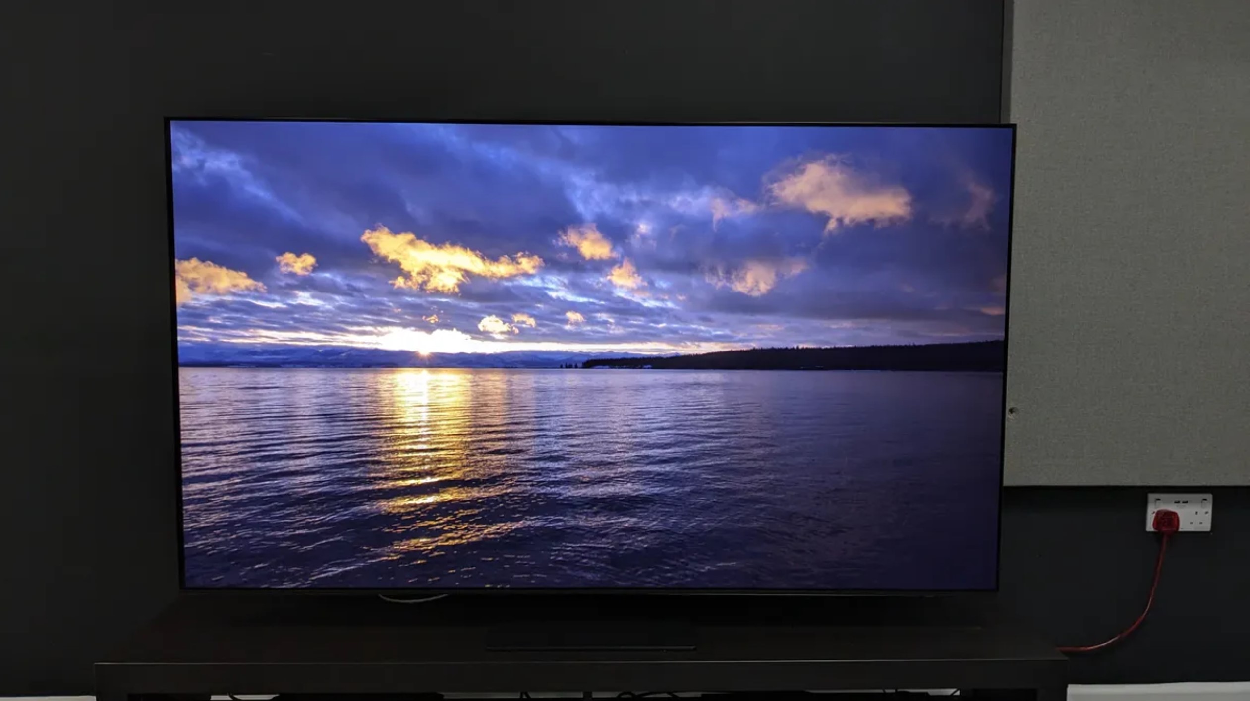 Samsung S95D showing image of sunset on lake