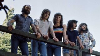 Moody Blues standing on a bridge