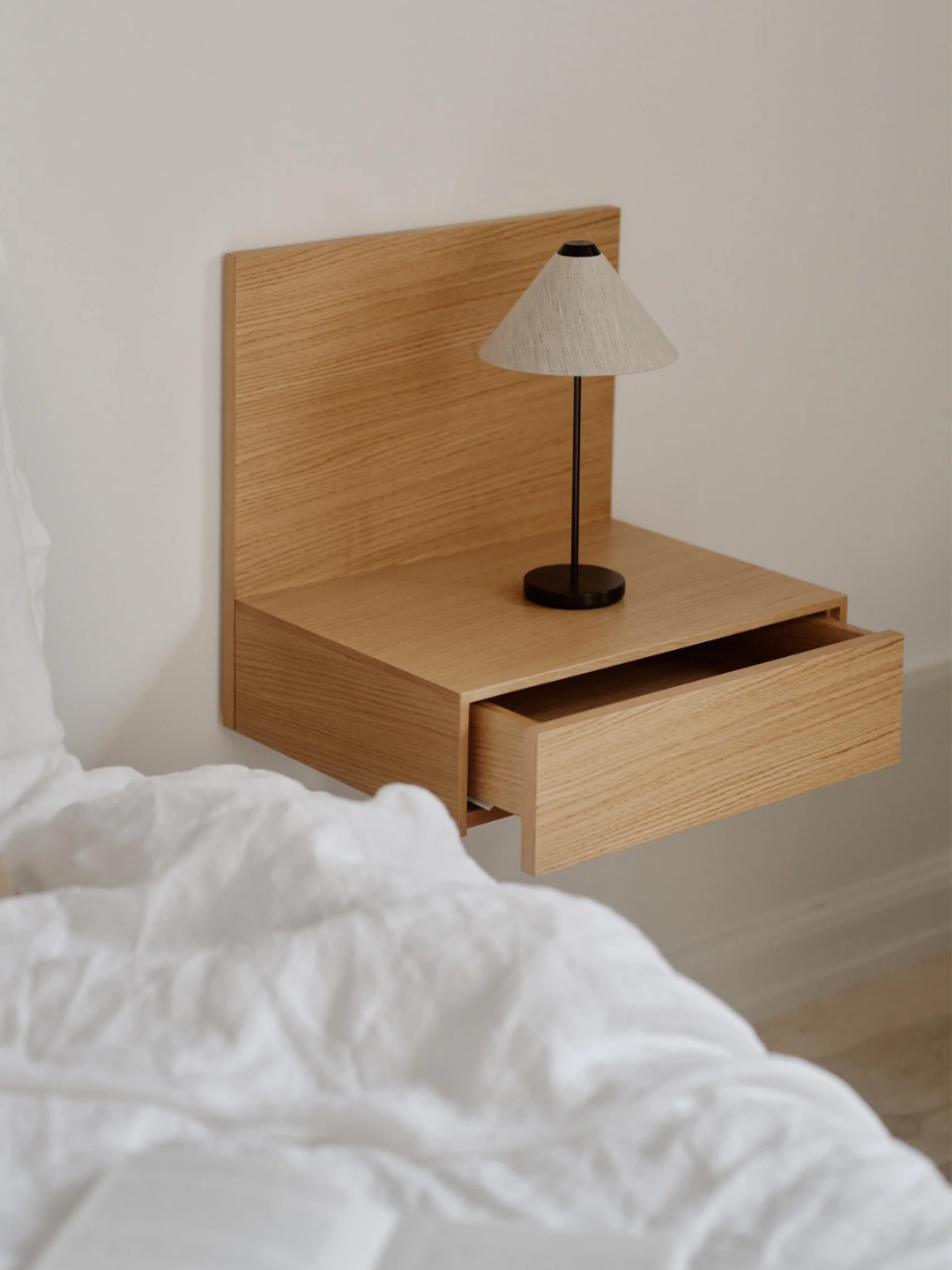 A wall-mounted bedside table from New Works