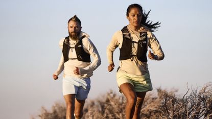 Trail runners wearing The North Face Lightrange outfit as they run on the hills