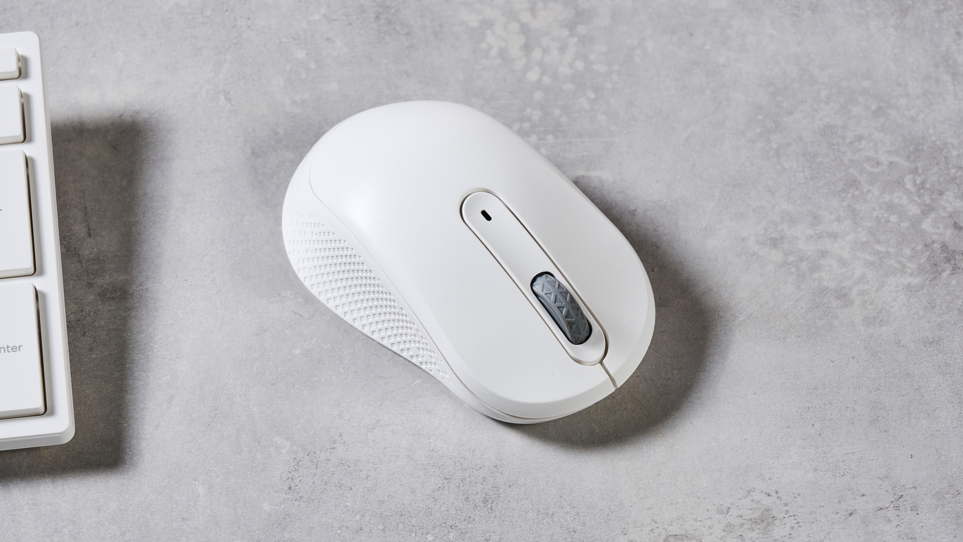 Close-up of mouse included with Acer Aspire C24, on a grey desk