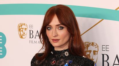 Sophie Turner with red hair and bangs at the EE BAFTA Film Awards in London on February 19, 2023