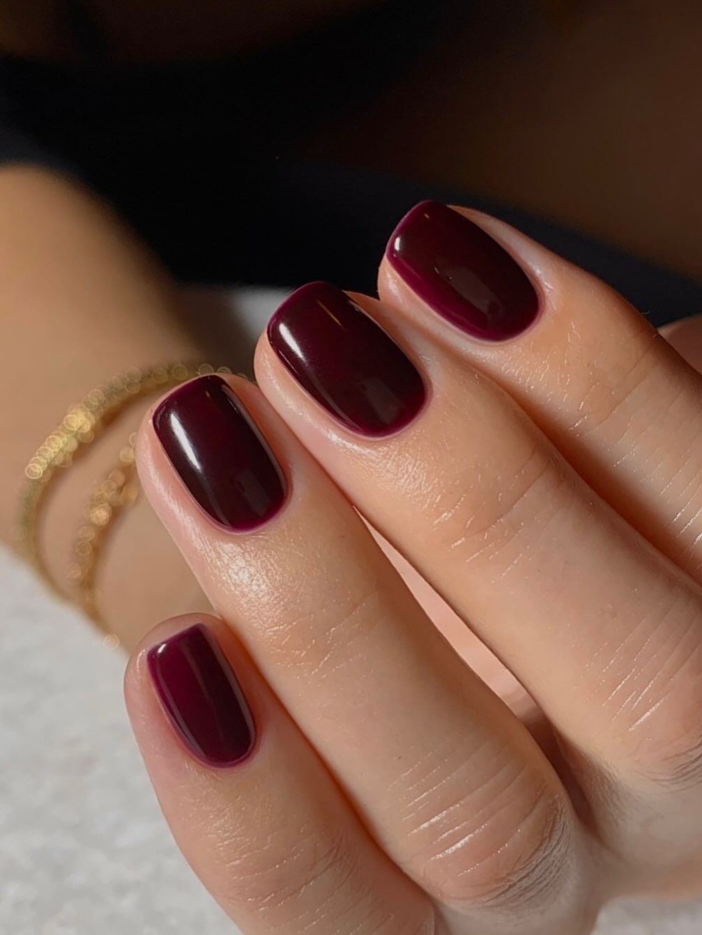 Squoval nails with dark red polish by Georgia Rae