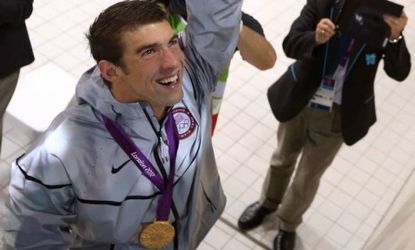 Gold medalist U.S. swimmer Michael Phelps celebrates following the medal ceremony for the Men's 4 x 200m freestyle relay final on July 31: Phelps has now taken the record for the most Olympic