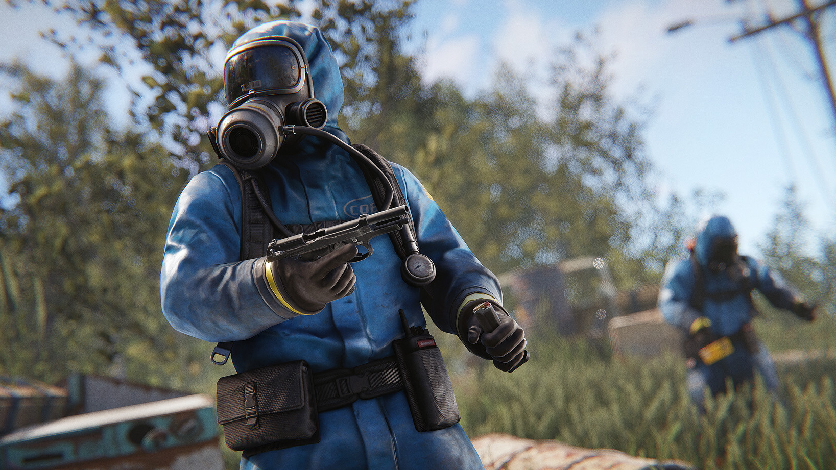 Two people in hazmat suits with guns