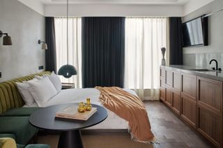 A hotel room fuses modern rustic and glamour for a striking and shapes-filled result.