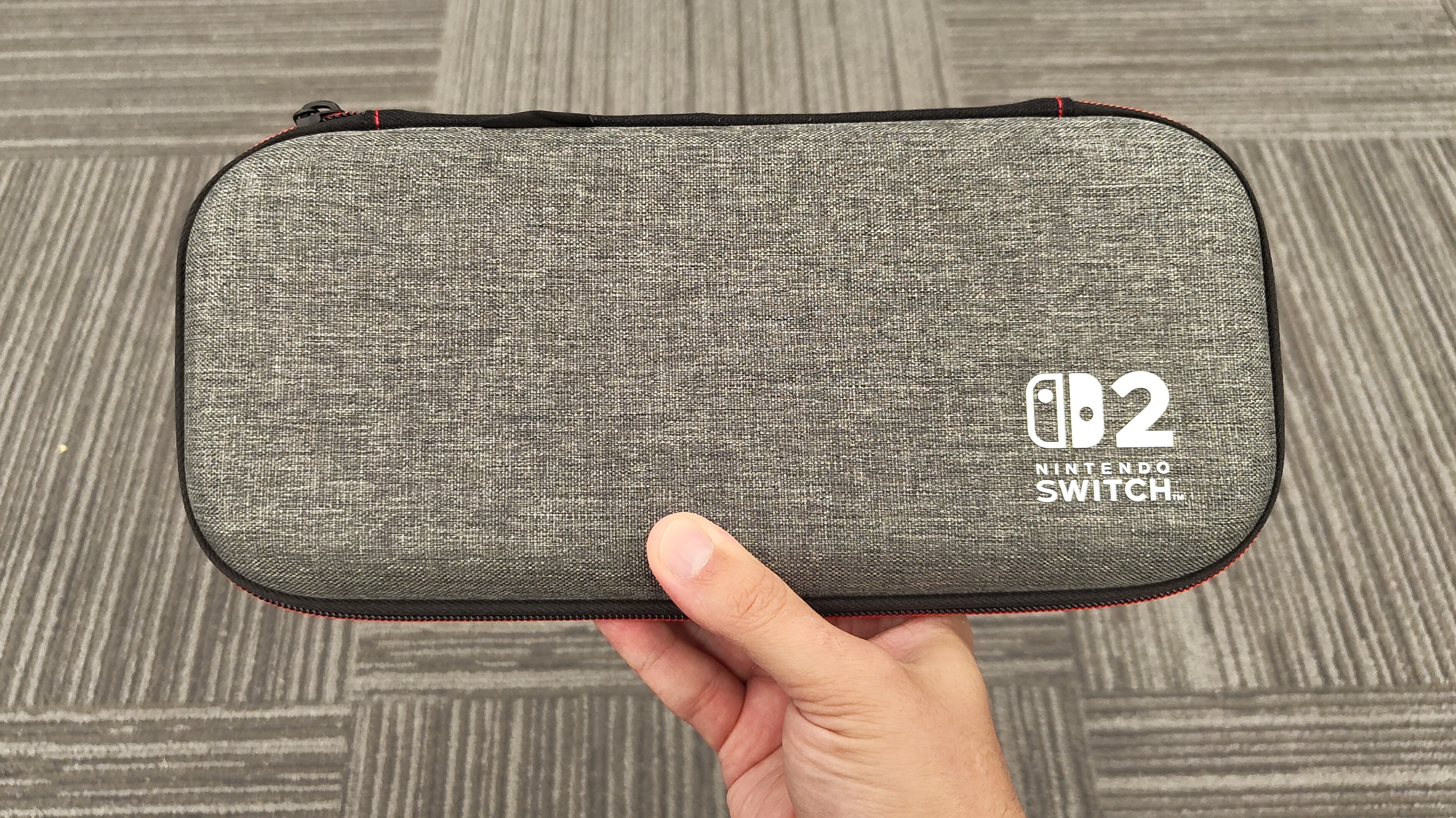 A picture of a person holding a Switch 2 in the PowerA Slim Case for Nintendo Switch 2