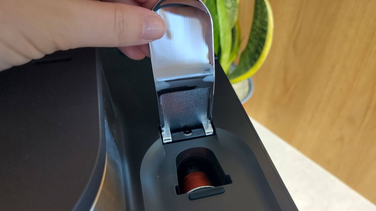 Person closing Ninja Prestige Dual-Brew System capsule holder