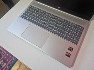 A silver HP Pavilion 16 sitting on a white desk