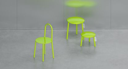 Neon green chair, stool and side table photographed in the grey room