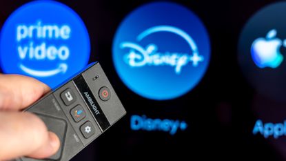 TV remote pointing at Disney+ app (blurred with bokeh)