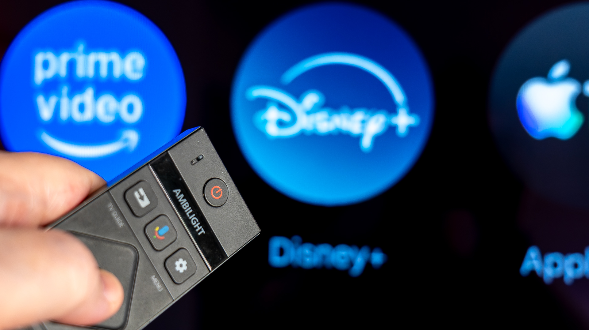 TV remote pointing at Disney+ app (blurred with bokeh)