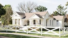 exterior of large white house from fixer upper