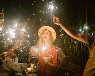 group of people holding sparklers party