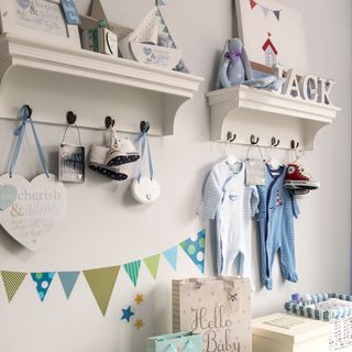 Blue nursery with multiple storage options on the wall