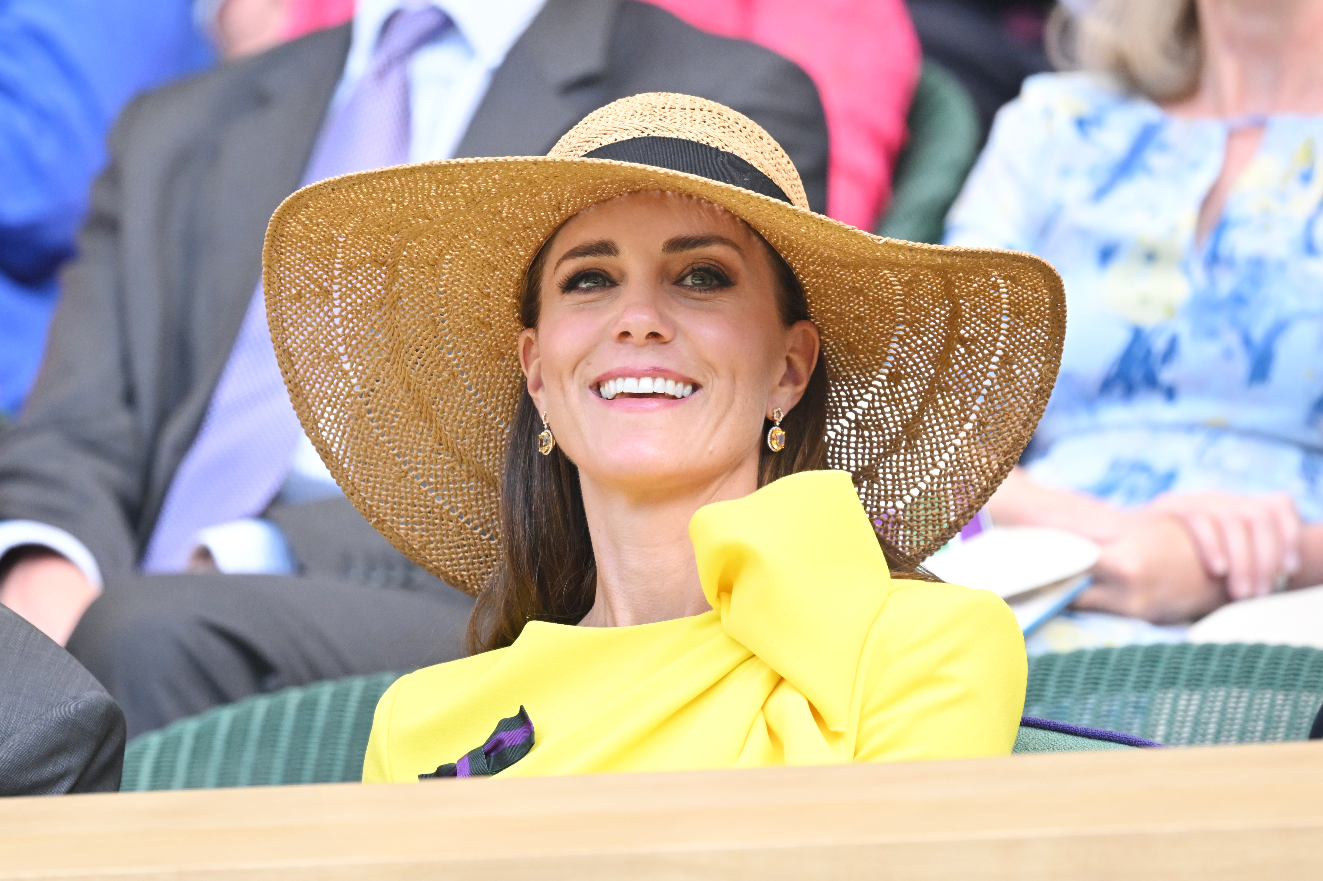 Kate Middleton wearing a yellow dress and sun hat at Wimbledon