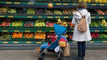 What is inflation symbolised by a woman choosing fruit in a supermarket