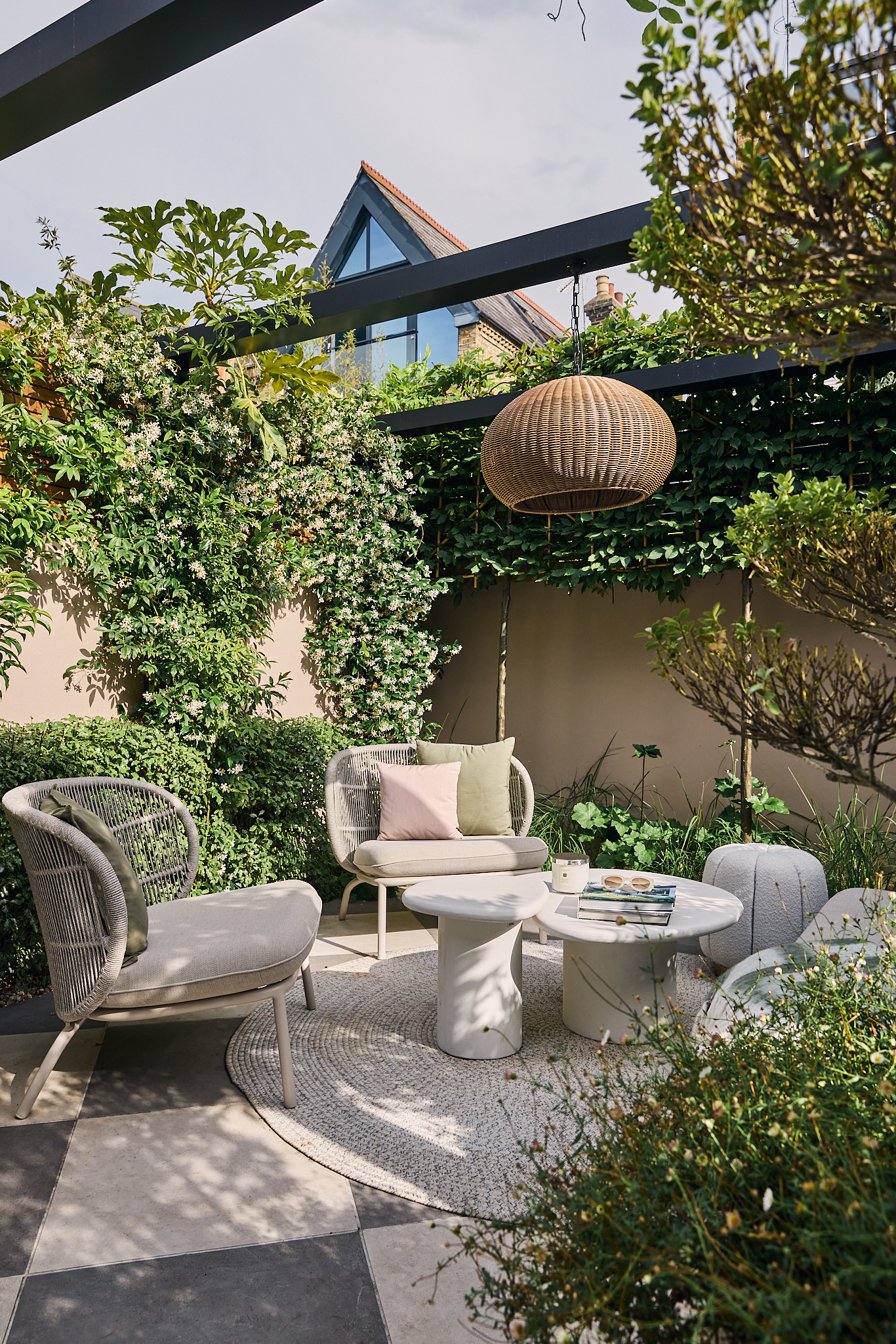 a modern garden filled with plants with a large checkerboard floor