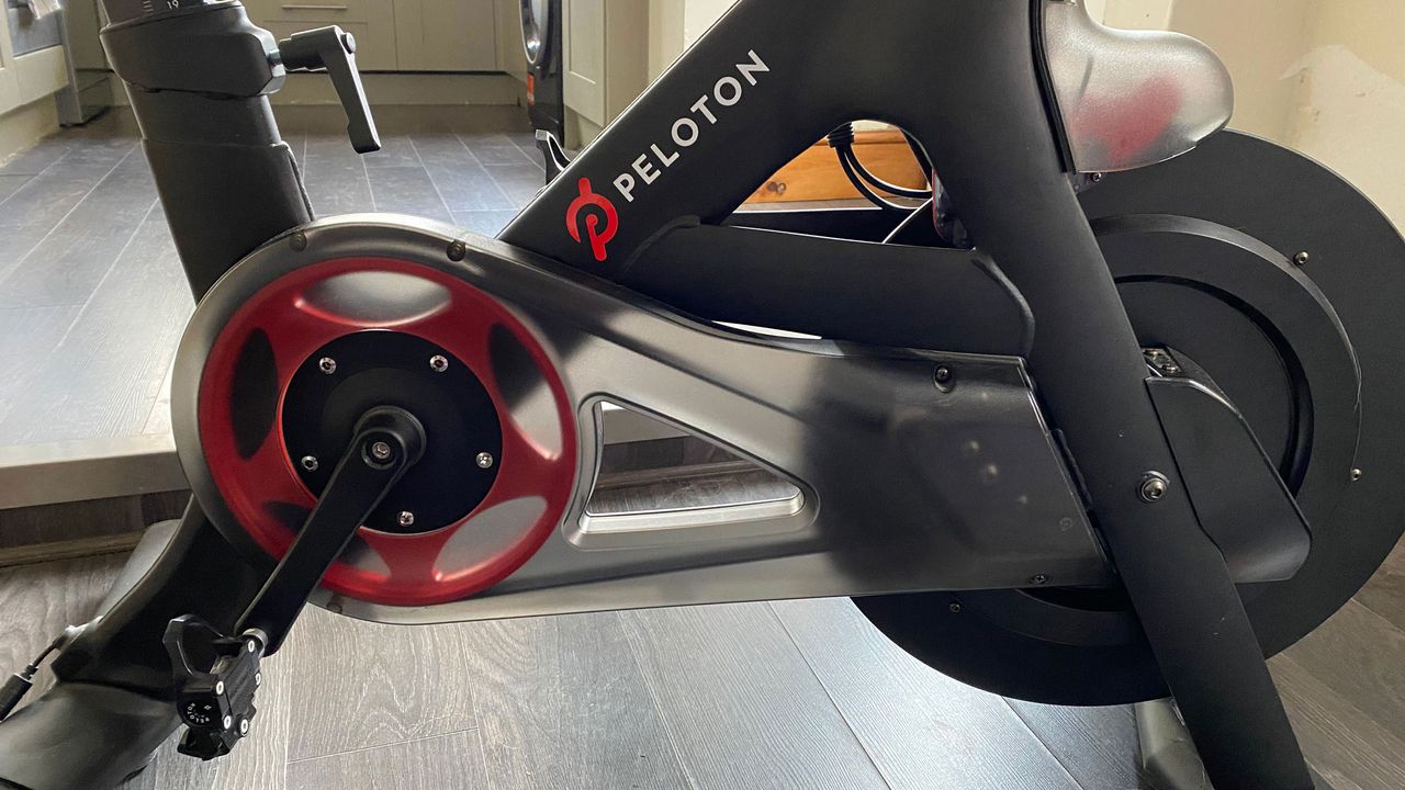 A close-up picture of the pedals and flywheel on the Peloton bike
