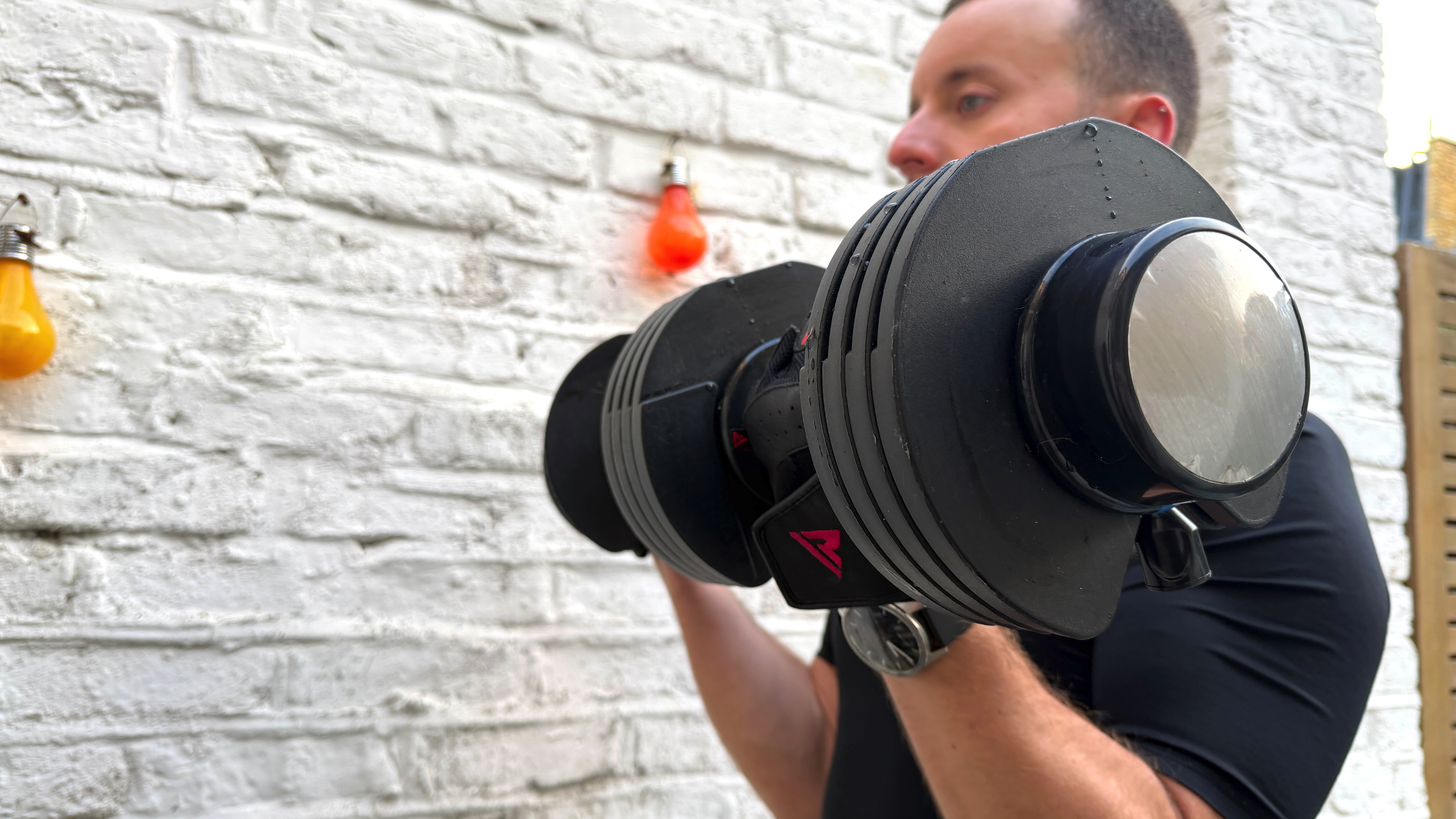 James Frew working out with the LifePro PowerFlow Plus in front of a painted white wall