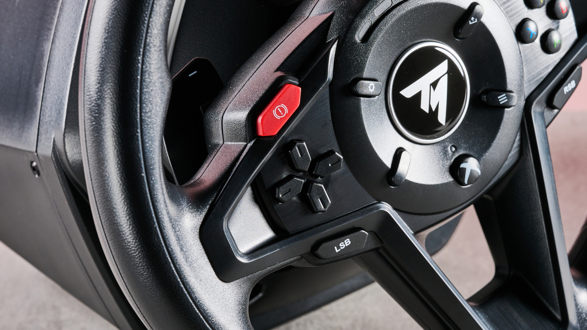 Close-up of D-pad and handbrake button on Thrustmaster T128