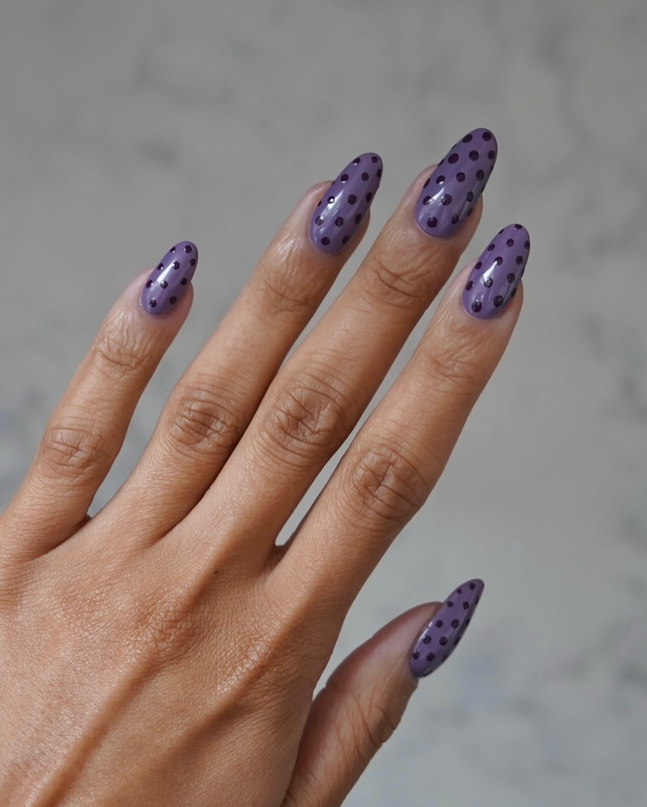 Purple polka dot nails.
