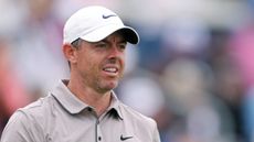 Rory McIlroy wearing a brown polo and white cap during the US Open