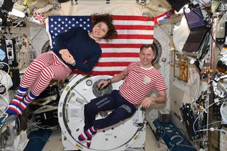 Two NASA astronauts beamed home their holiday wishes from the International Space Station today (July 4).