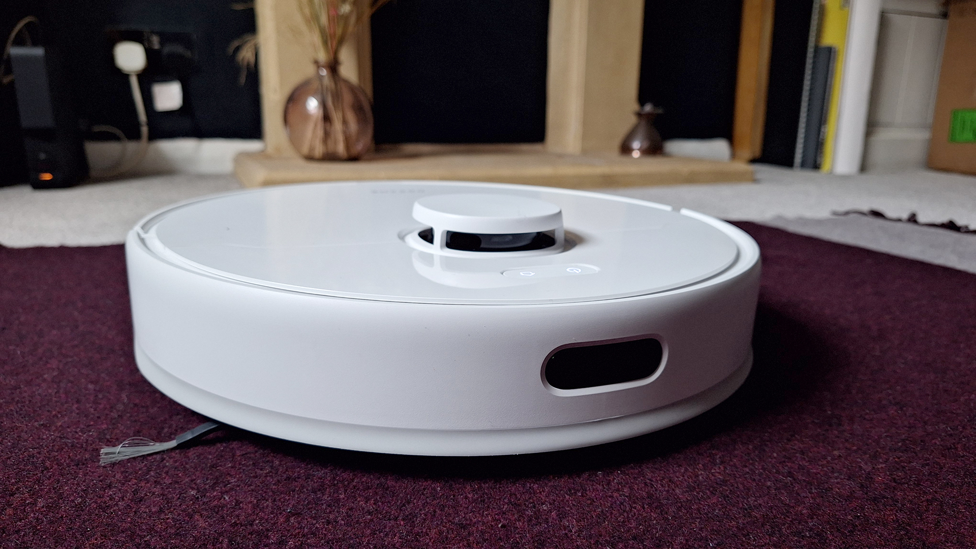 Dreame D9 Max Gen 2 robot vacuum in front of fireplace in reviewer&#039;s home