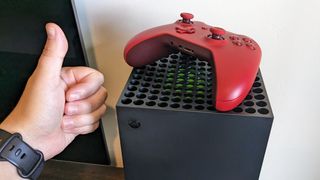 Xbox Series X with controller and a thumbs up.