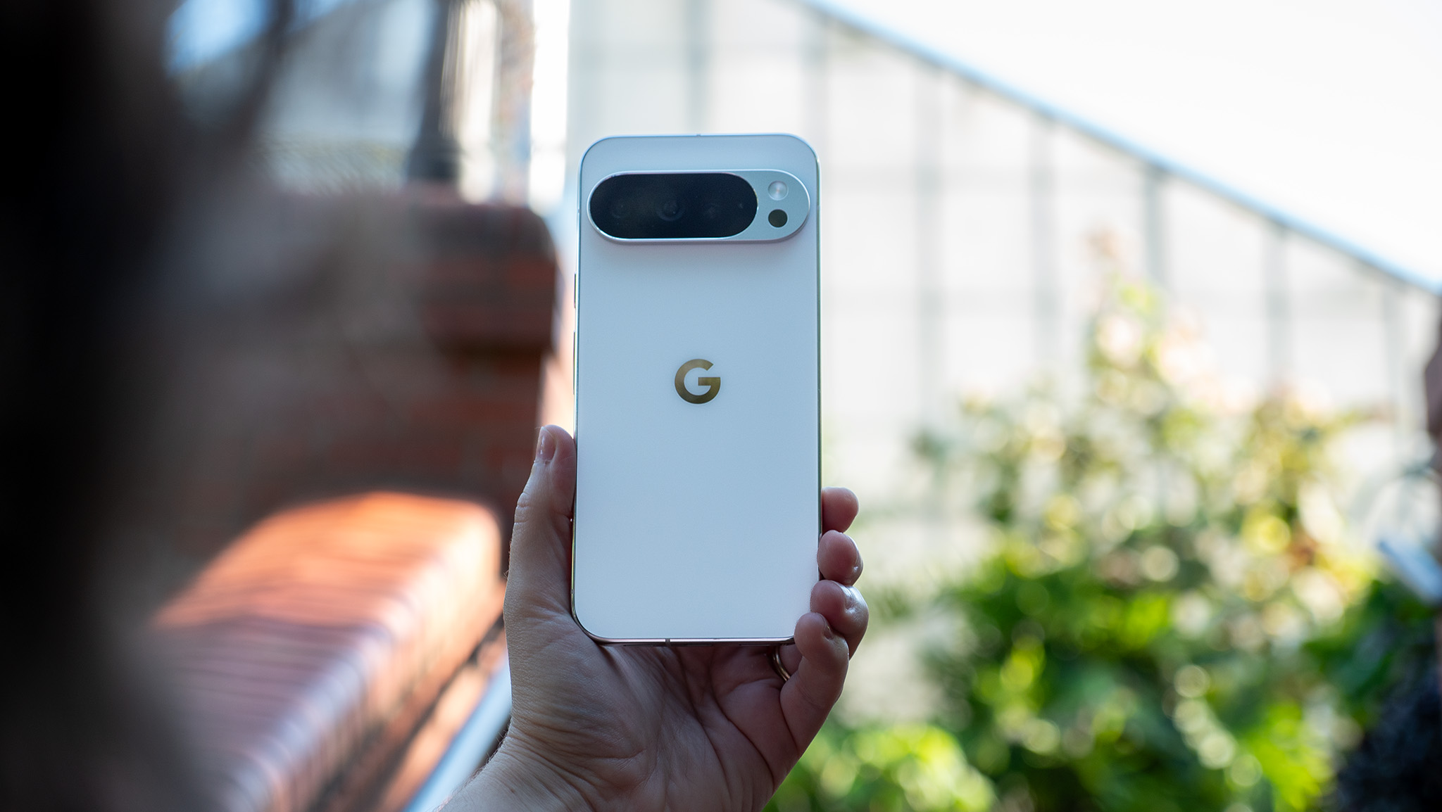 Holding a white Google Pixel 10 Pro XL