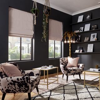 living room with black wall and armchairs