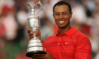 Tiger Woods poses with the Claret Jug following his third Open Championship victory at Royal Liverpool.