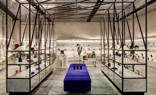 Shoe department featuring a long, padded blue bench