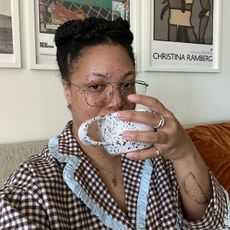 A woman taking a selfie drinking a cup of coffee