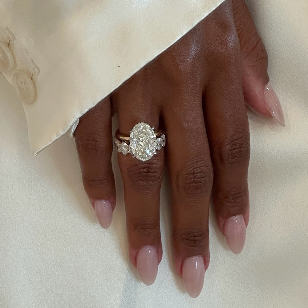 A close-up of Jas Tookes hands with a pink nail polish colour and almond nail shape