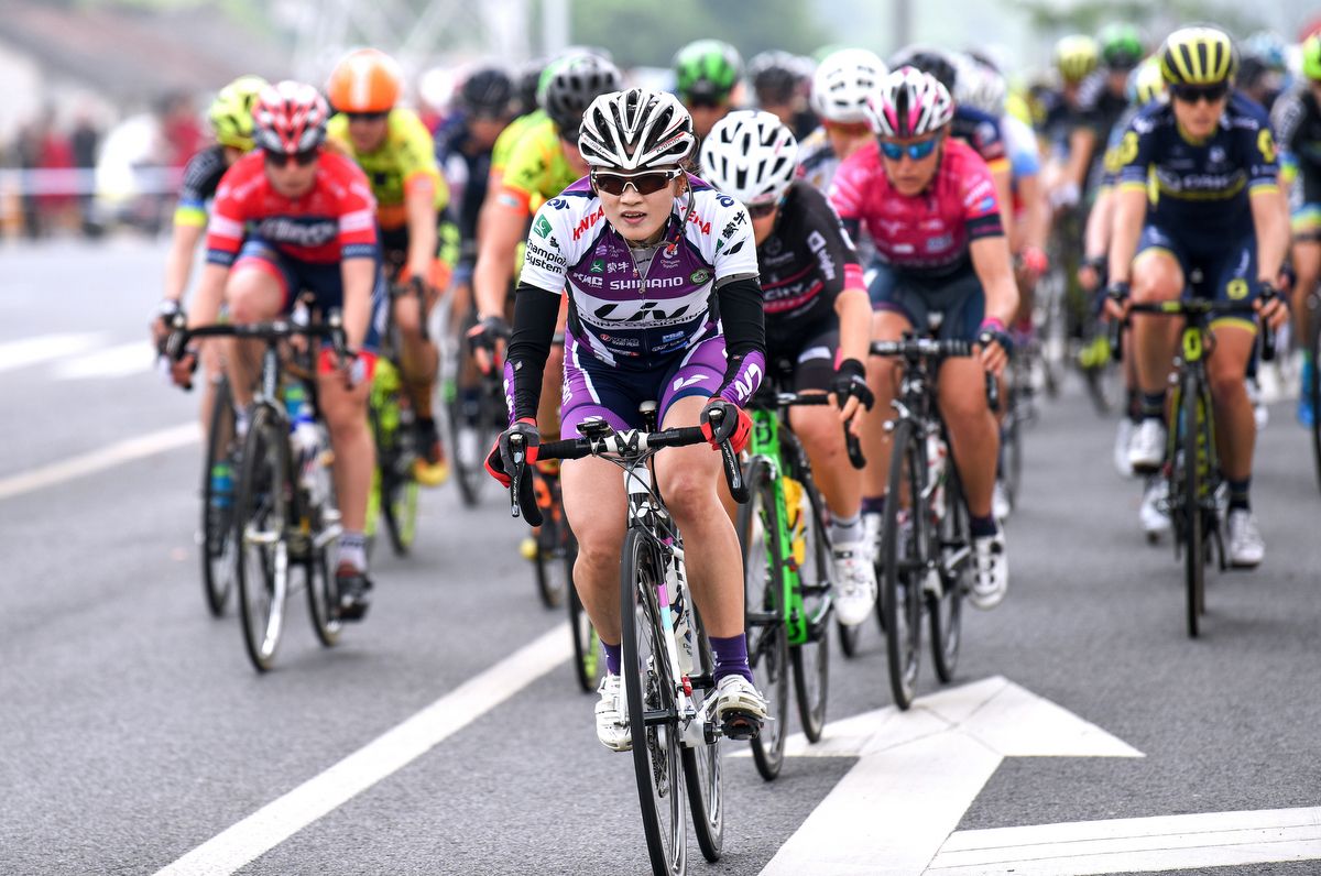 A local Chinese rider comes to the head of the peloton