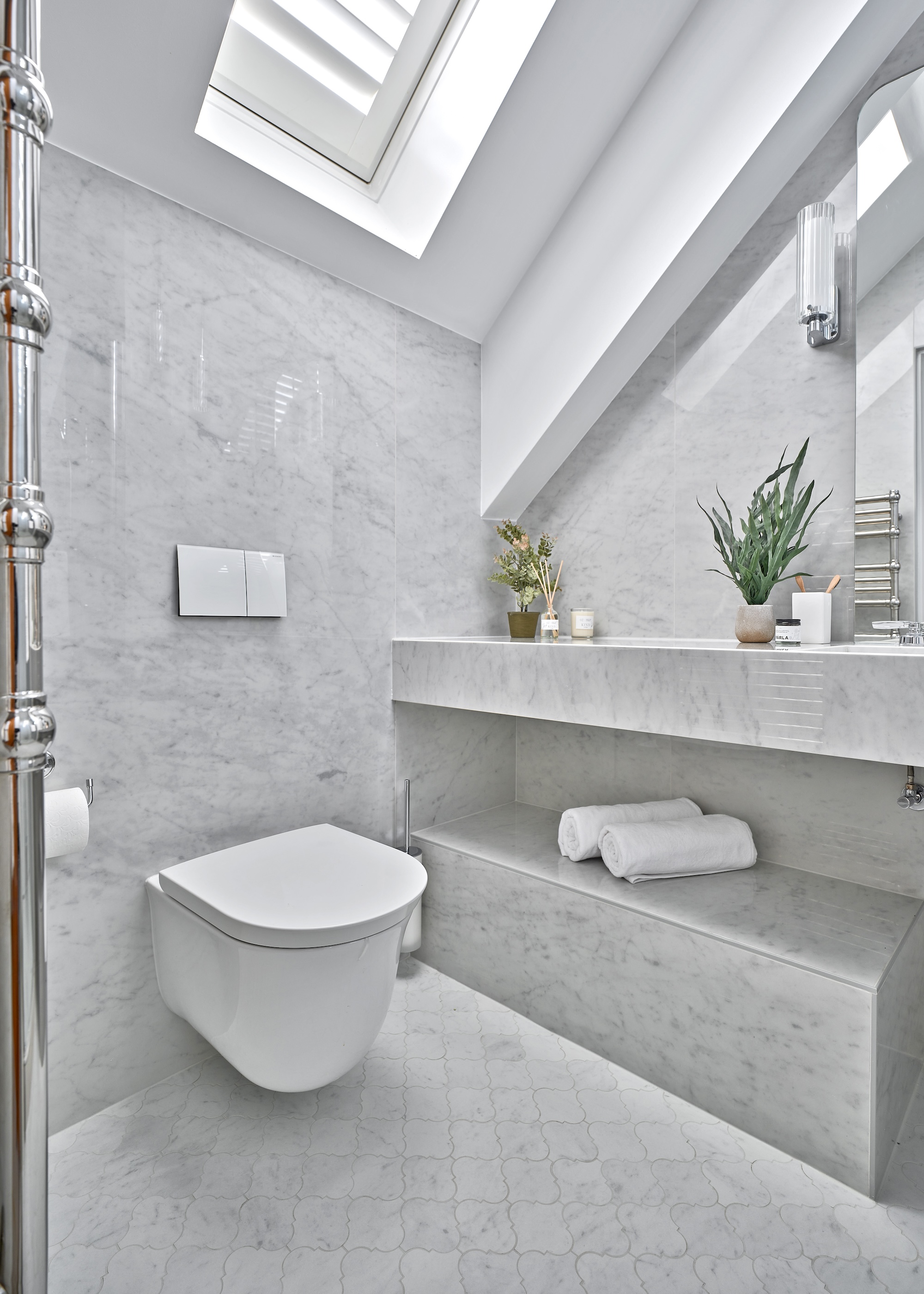 a grey bathroom with grey features and a view of the toilet as well as countertops.