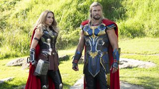 Thor and Jane Foster's Mighty Thor stand next to each other on a green field in Thor: Love and Thunder