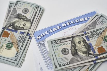 Social security card and US dollars cash money on white. Social security benefits. 