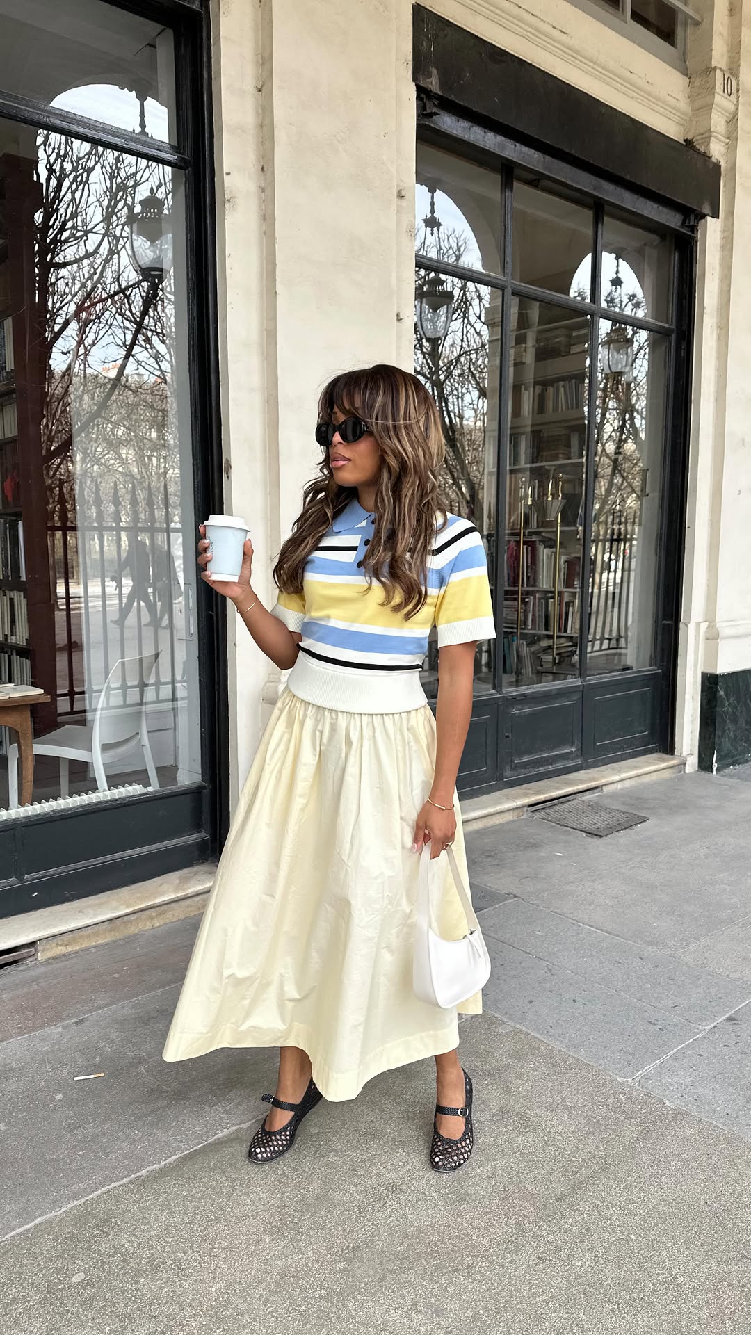 Woman in pale yellow skirt and polo top