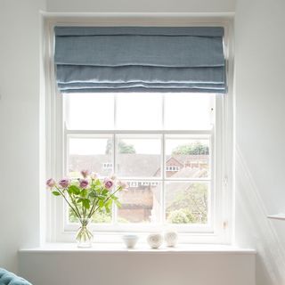 white window with flower vase and outdoor view