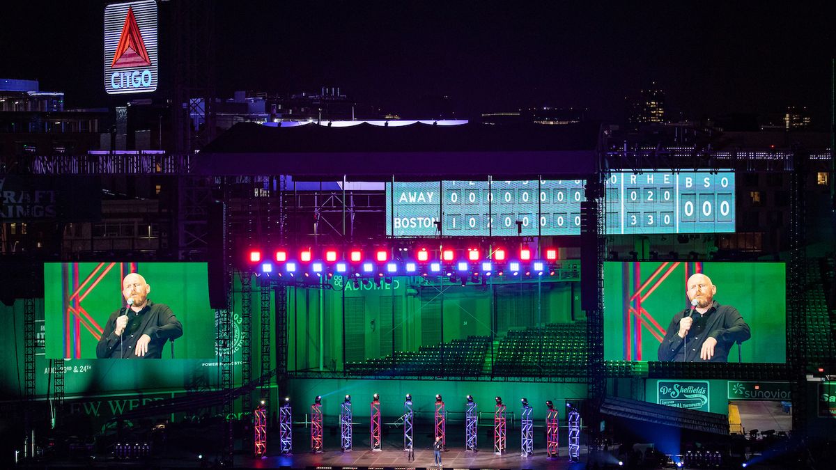 Bill Burr takes the stage a a green-lit Fenway Park back by d&amp;b audiotechnik sound systems.