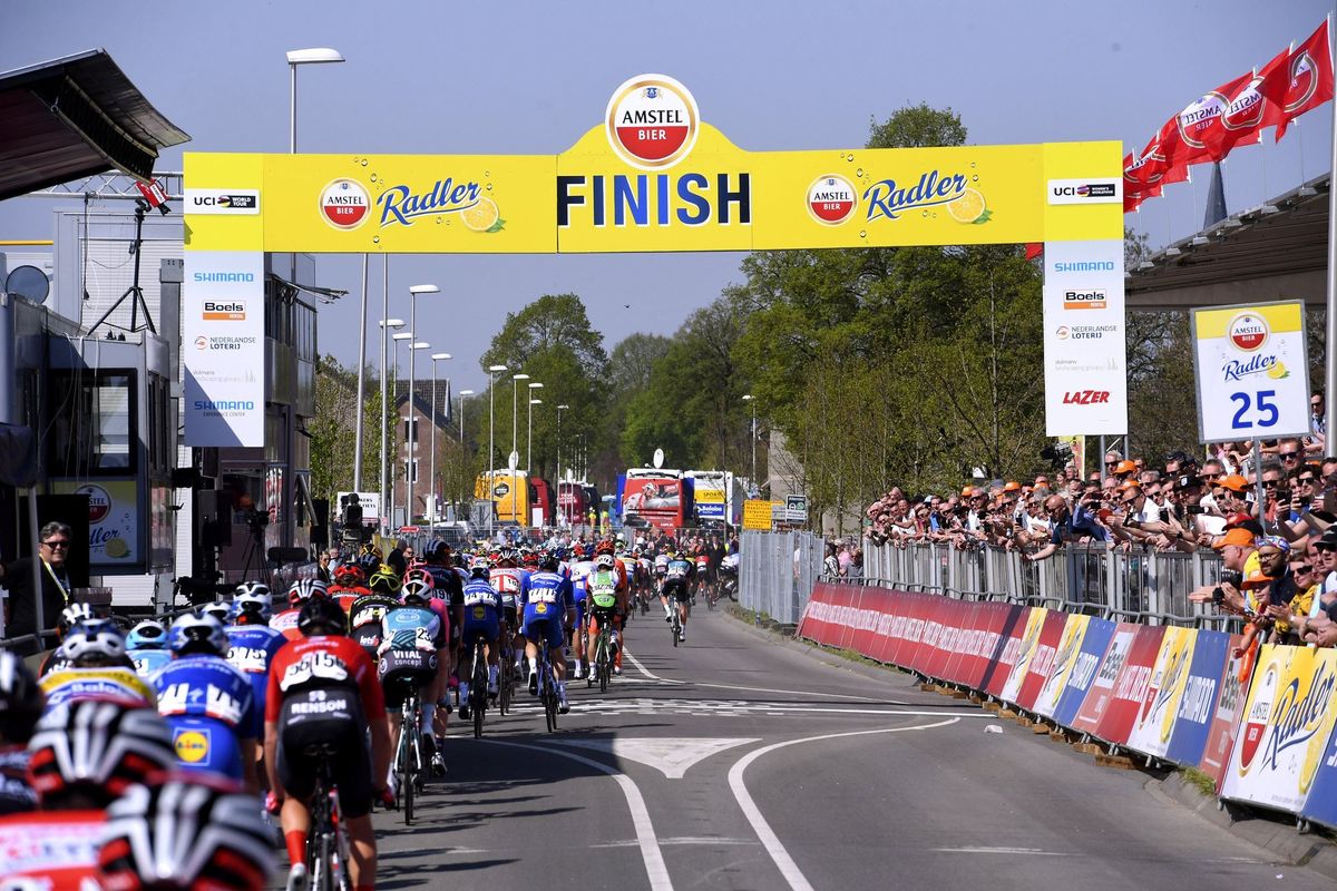 The peloton rolls through the finish line