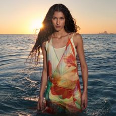 a model in the sea wearing the mango x siedres collaboration including a floral dress