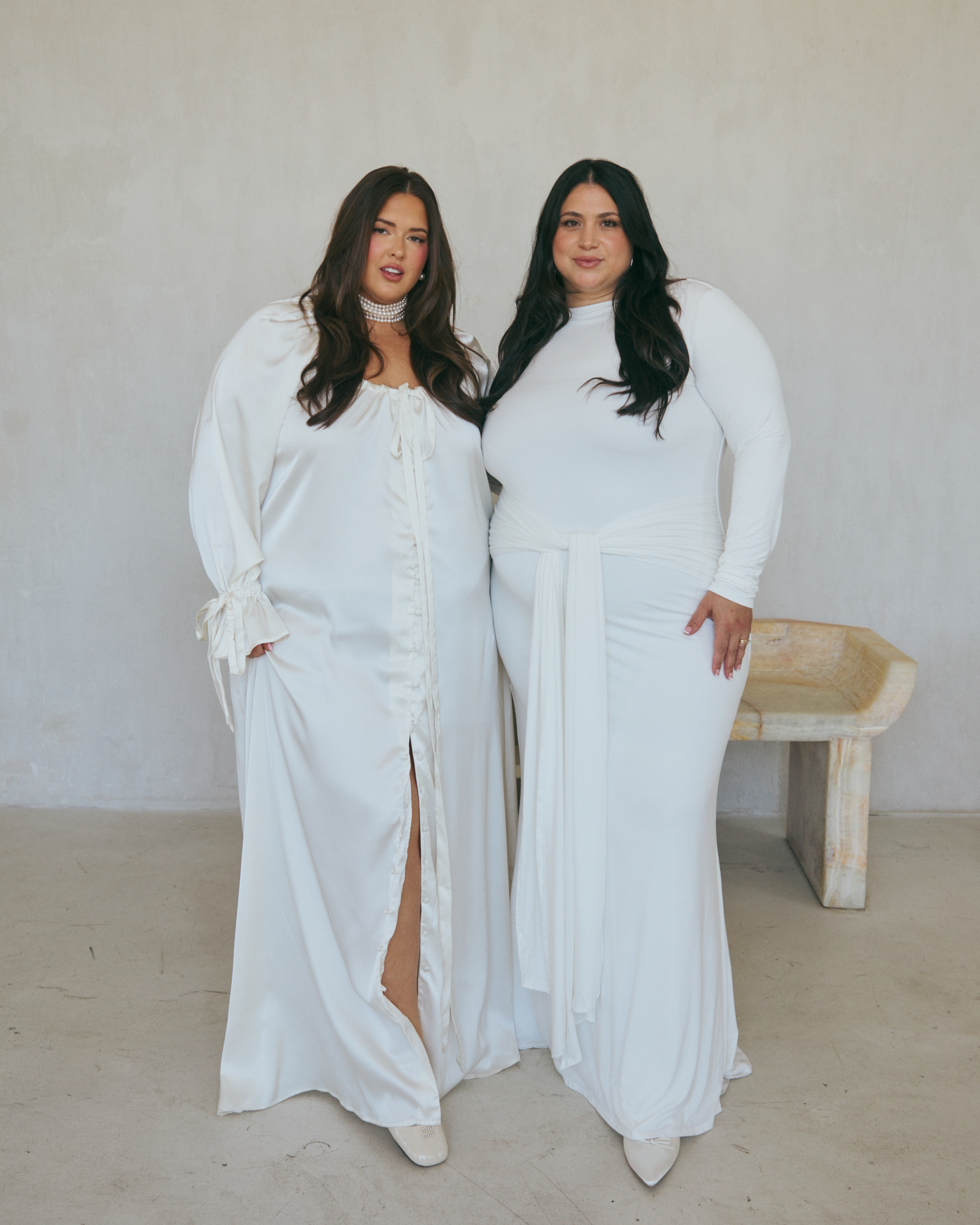 Emma Arletta and Gia Sinatra pose in the bridal collection they both recently debuted.