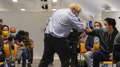 Boris Johnson meets patients during a visit to the vaccination centre