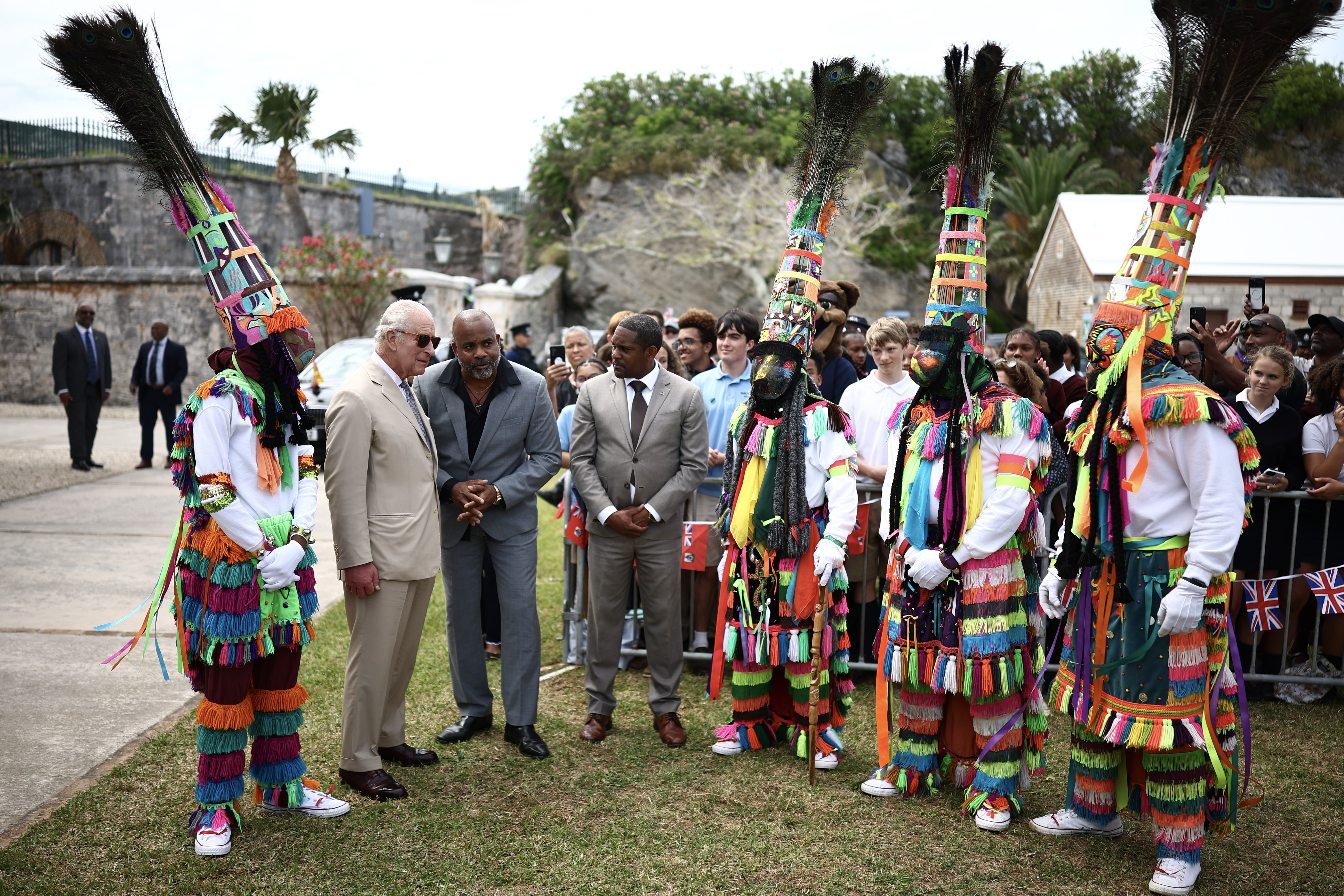 Britain's King Charles III is greeted by Gombey dancers during a cultural welcome at the Royal Naval Dockyard on May 1, 2026 in Sandys Parish, Bermuda
